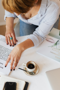 Woman working at a desk examining a form.