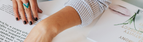 Woman working at a desk examining a form.
